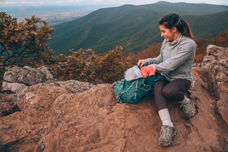 Picture outdoors showing Michelle looking through backpack